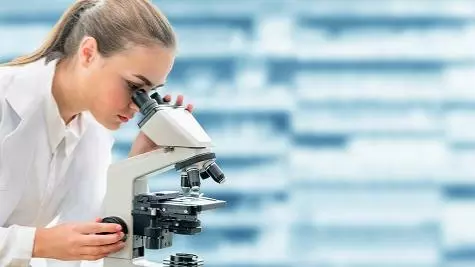 Scientist with a microscope