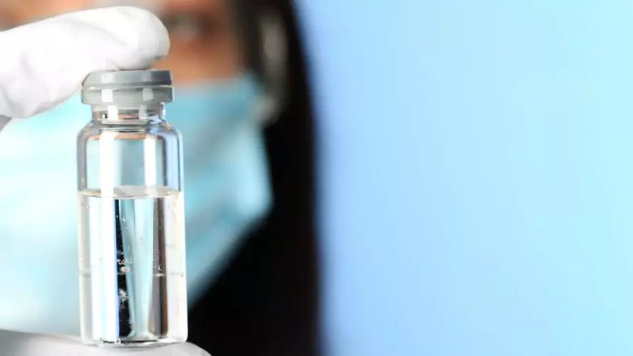 Scientist holding a vaccine vial