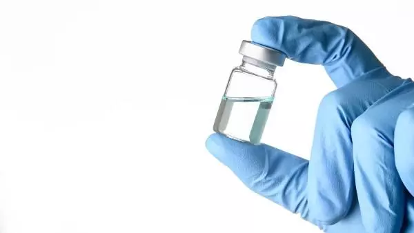 Scientist holding vaccine vial