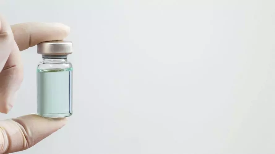 Vaccine Vial being held