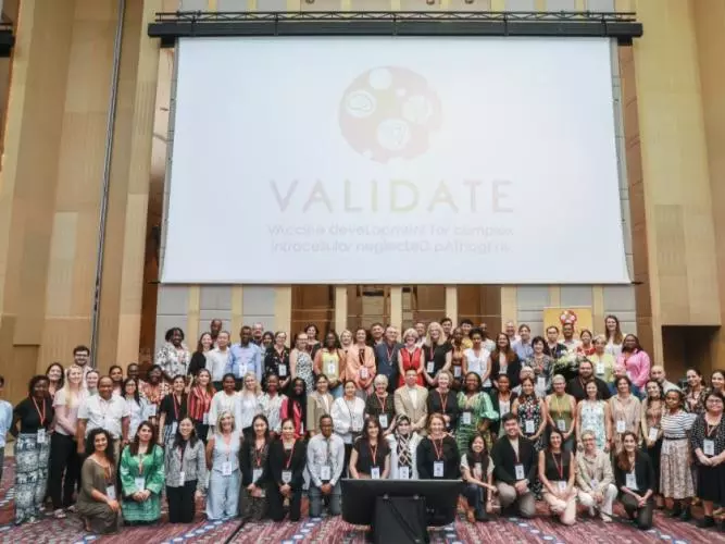 The VALIDATE Annual Meeting 2024 - A group photo of all delegates below the VALIDATE Logo