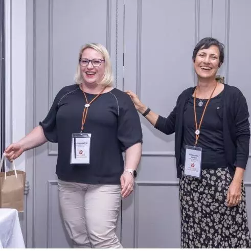 Nastassja (left), winning the best poster award at the VALIDATE Annual Meeting 2025